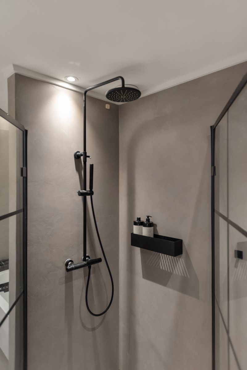 A walk in shower sitting next to a shower head
